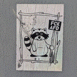 sticker of a racoon holding a sign 'FUCK AfD'