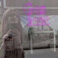 reflection of a face in a Copenhagen shop window with a neon sign that says 'Ges-icht'