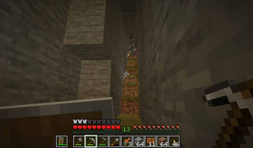 narrow cave with steep narrow dirt block stairs and torches.