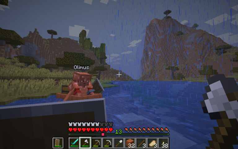 both expedition members in boats, rain, mountain in background
