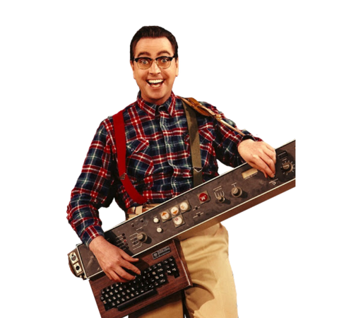 a man in a plaid shirt and suspenders where one strap is red and the other is green; he's holding a large device with dials and knobs and something similar to a c64 on the bottom forming the shape of a guitar