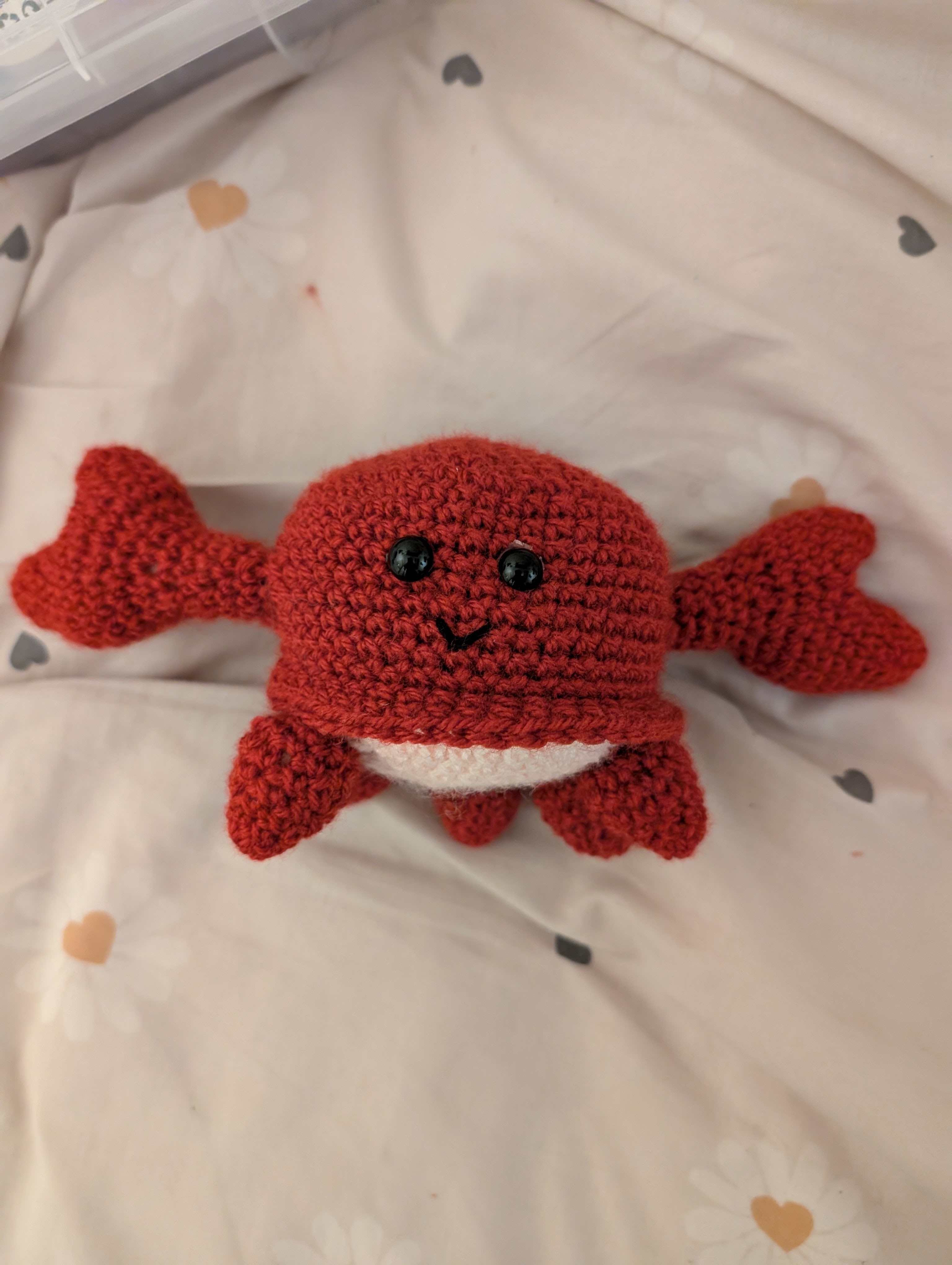 Photo of a happy crocheted 
crab