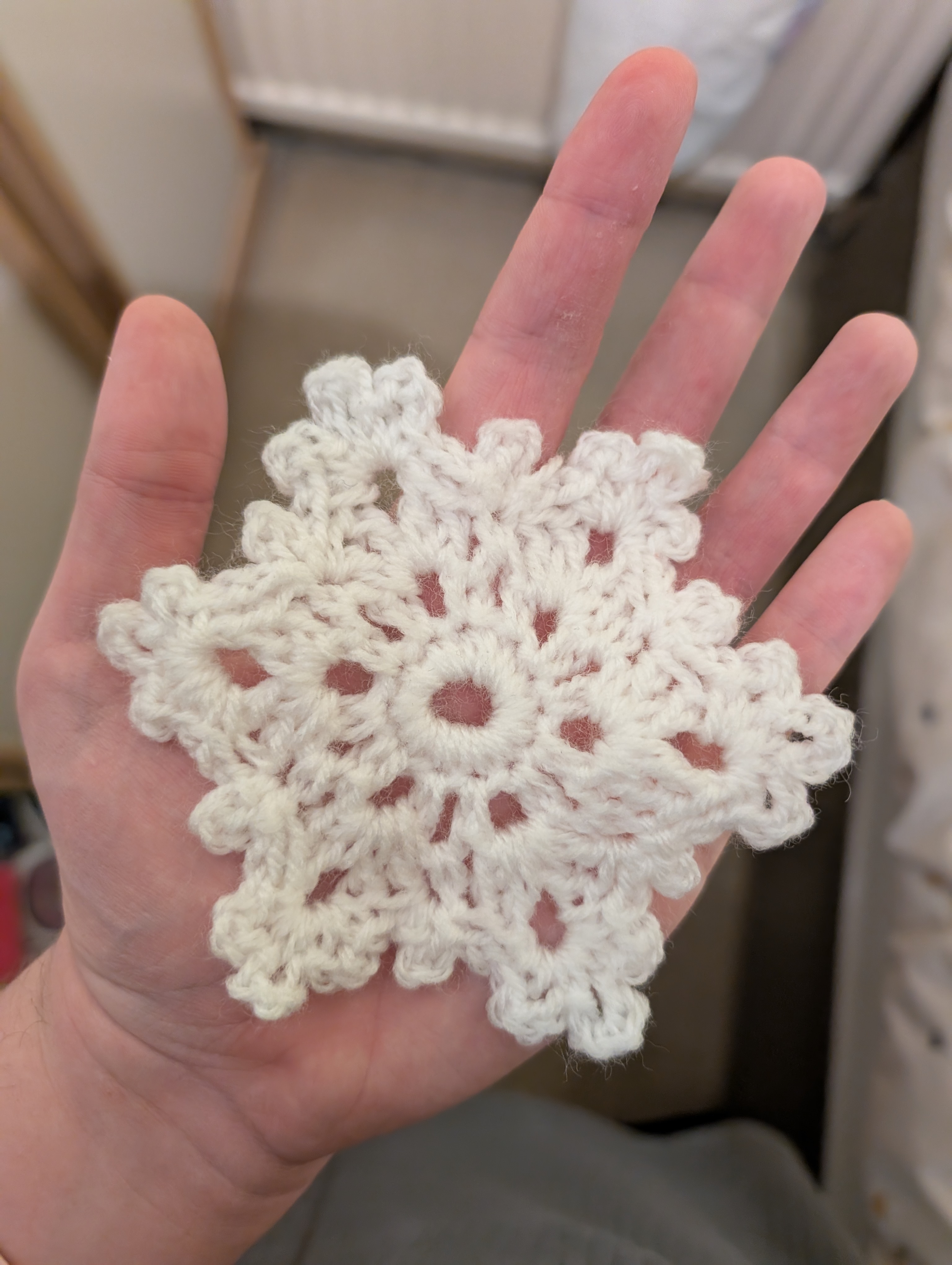 A crochet snowflake sat in my palm.